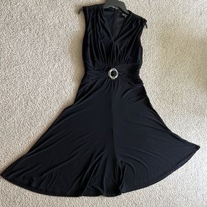 Flowy black cocktail dress with rhinestone buckle.